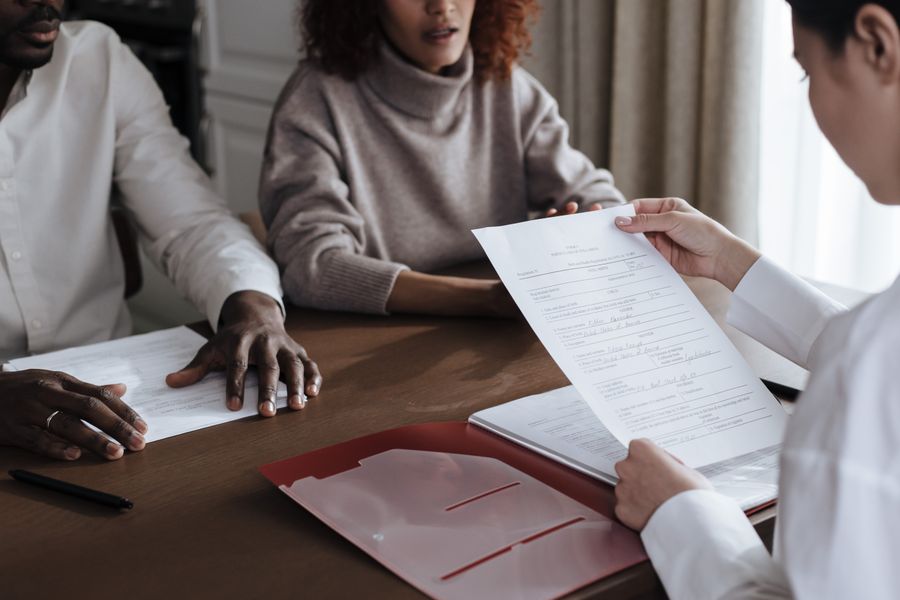 Black client discussing documents with a social worker