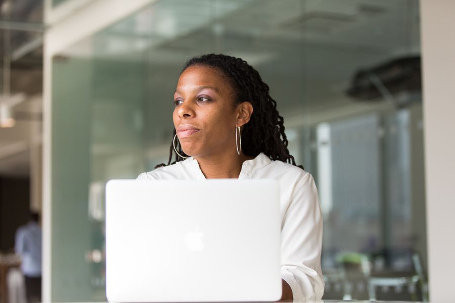 Black professional working on a laptop in an office